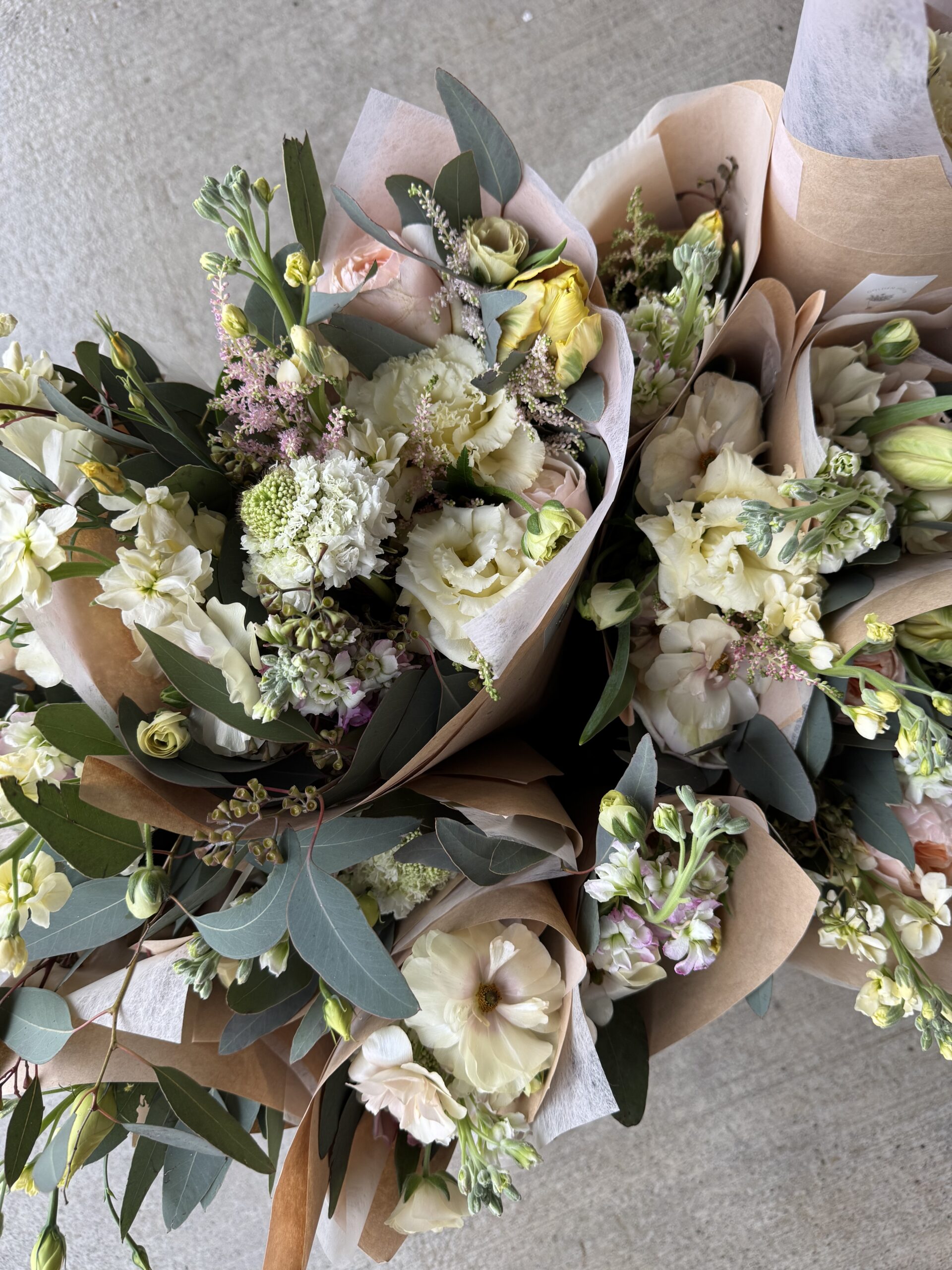 Cecile and Natasha of Golden Hour Blooms Co. building wildflower arrangements together at one table